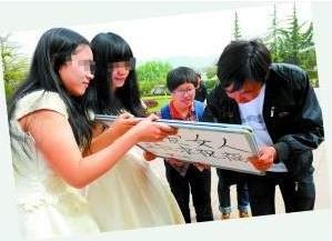 蘭州女大學生同性戀穿婚紗辦婚禮，高舉“拉拉求祝?！睒苏Z牌